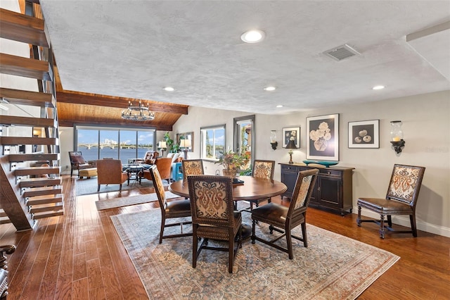 761 Marina Point Dr Unit 7610, Daytona Beach, FL 32114 - dining area with stairs, visible vents, vaulted ceiling, and wood finished floors