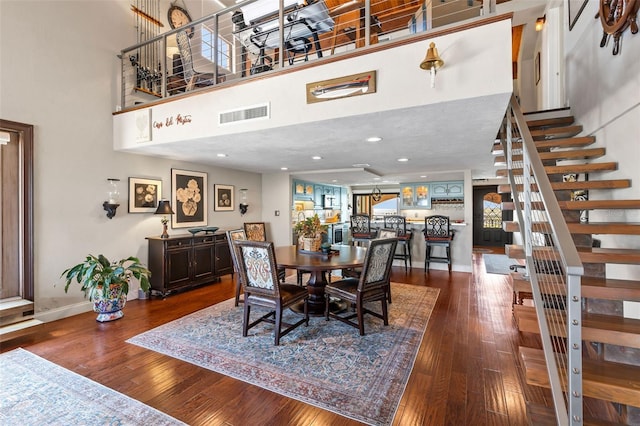761 Marina Point Dr Unit 7610, Daytona Beach, FL 32114 - dining area featuring stairs, a towering ceiling, visible vents, and dark wood-style floors