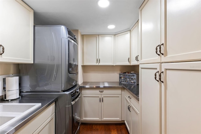 761 Marina Point Dr Unit 7610, Daytona Beach, FL 32114 - laundry area with dark wood-type flooring, stacked washing maching and dryer, cabinet space, and recessed lighting