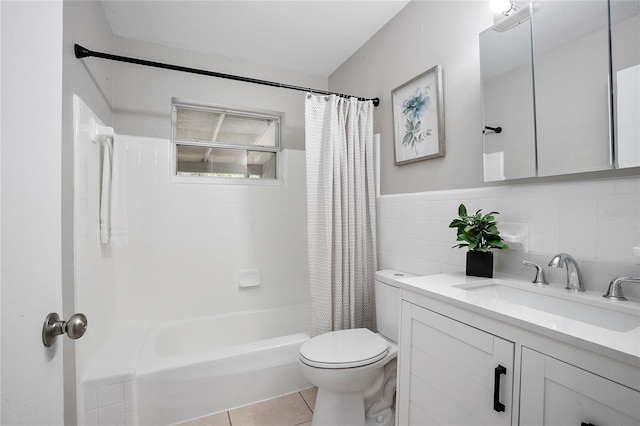 full bath featuring vanity, tile patterned flooring, toilet, tile walls, and shower / bath combo with shower curtain