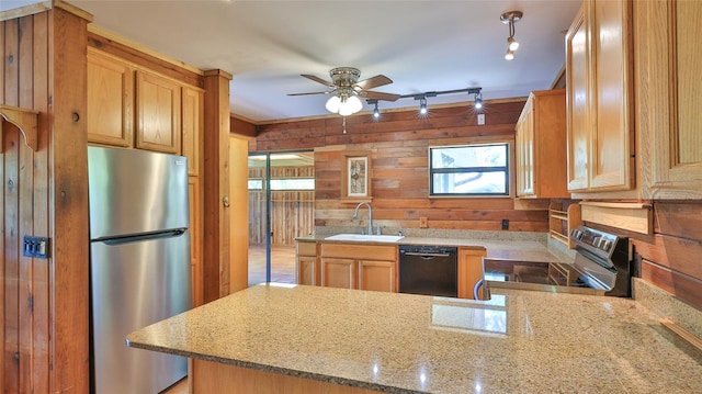 160 Rose Ave, Lake Helen, FL 32744 - kitchen with stainless steel appliances, a peninsula, a sink, a ceiling fan, and wooden walls