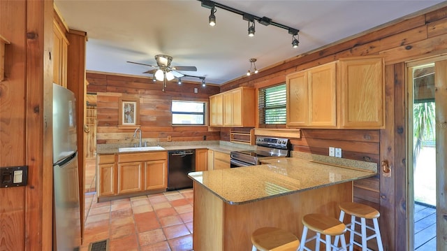 160 Rose Ave, Lake Helen, FL 32744 - kitchen with a peninsula, a sink, visible vents, wood walls, and appliances with stainless steel finishes