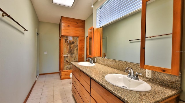 160 Rose Ave, Lake Helen, FL 32744 - full bath with double vanity, tile patterned flooring, baseboards, and a sink
