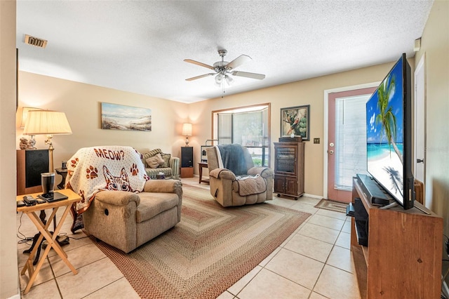 8 Faith Ln, Palm Coast, FL 32137 - living area featuring light tile patterned floors, a ceiling fan, visible vents, and a textured ceiling