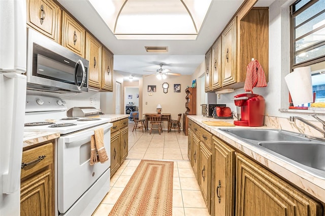 8 Faith Ln, Palm Coast, FL 32137 - kitchen with a sink, visible vents, brown cabinetry, and white appliances
