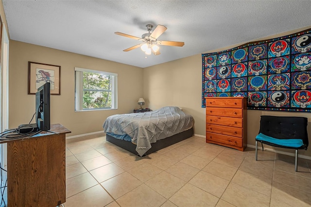 8 Faith Ln, Palm Coast, FL 32137 - bedroom with light tile patterned floors, baseboards, ceiling fan, and a textured ceiling