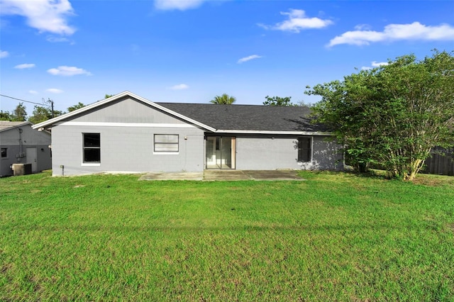 rear view of house with a yard and a patio area
