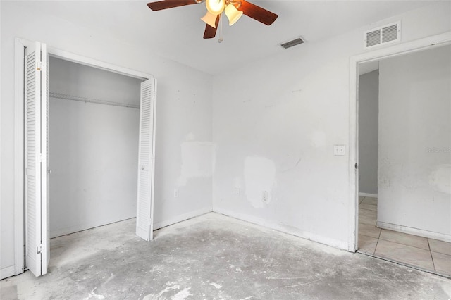 unfurnished bedroom with visible vents, a closet, and concrete flooring