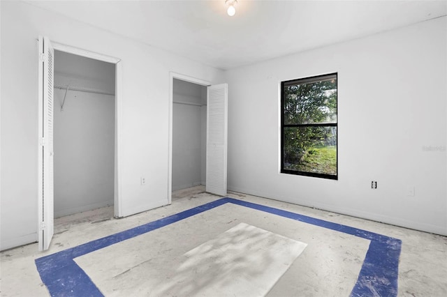 unfurnished bedroom with multiple closets