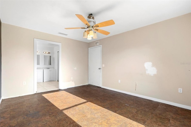 empty room with visible vents, baseboards, and a ceiling fan