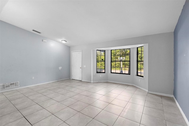 unfurnished room with visible vents, baseboards, and light tile patterned floors