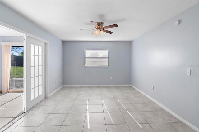 unfurnished room featuring a healthy amount of sunlight, light tile patterned floors, baseboards, and a ceiling fan