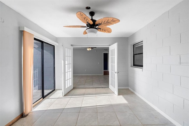 interior space featuring french doors, ceiling fan, light tile patterned flooring, and baseboards