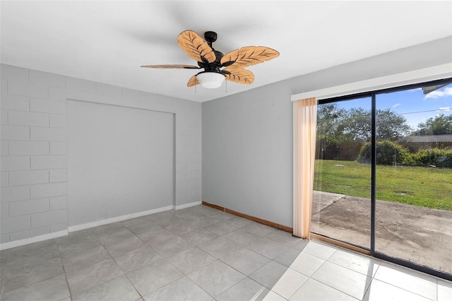 spare room with baseboards, light tile patterned flooring, and ceiling fan
