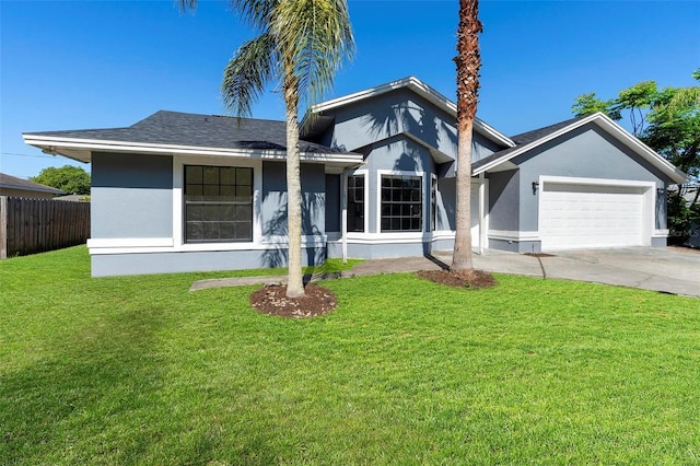 view of front of home featuring stucco siding, fence, a front lawn, a garage, and concrete driveway