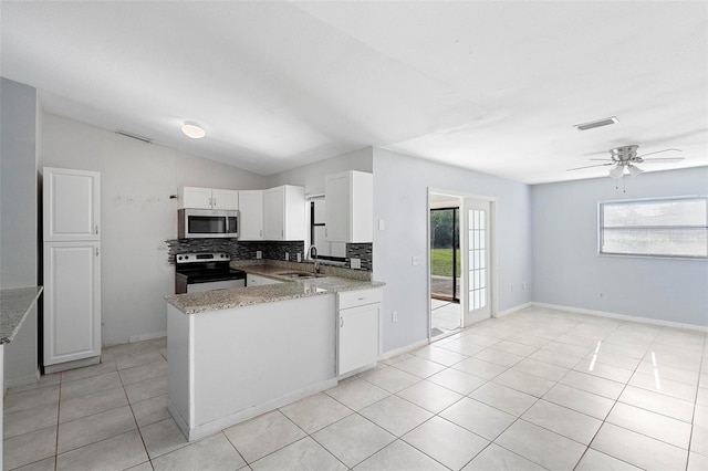 kitchen featuring a healthy amount of sunlight, a sink, backsplash, and appliances with stainless steel finishes
