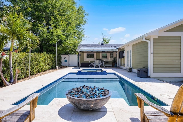 view of pool featuring a patio area, a pool with connected hot tub, a fenced backyard, and french doors