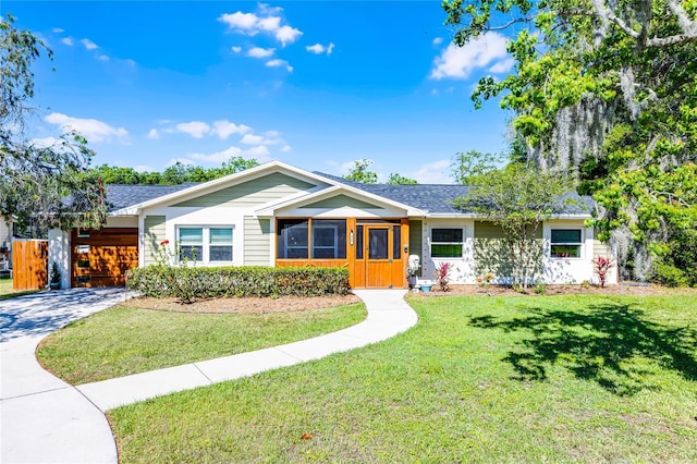 ranch-style home featuring a front yard and driveway