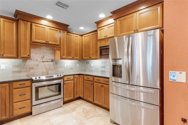 kitchen with brown cabinets, backsplash, visible vents, and stainless steel appliances