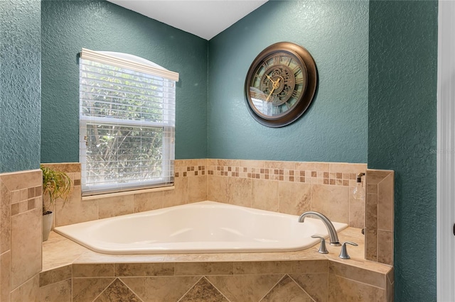 full bathroom with a bath and a textured wall