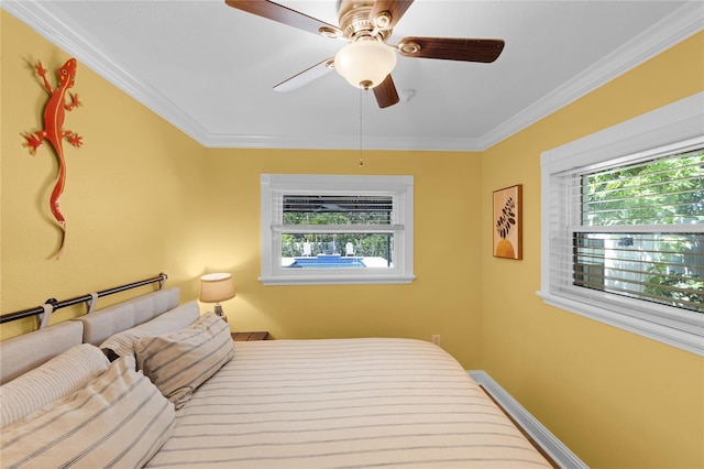 bedroom featuring a ceiling fan, crown molding, and multiple windows