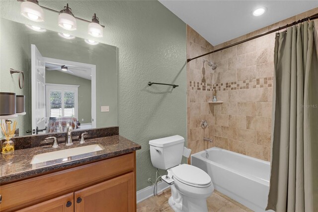bathroom with vanity, baseboards, vaulted ceiling, a textured wall, and shower / tub combo with curtain