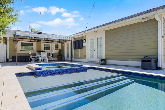 rear view of house featuring a patio area, french doors, ceiling fan, and a pool with connected hot tub