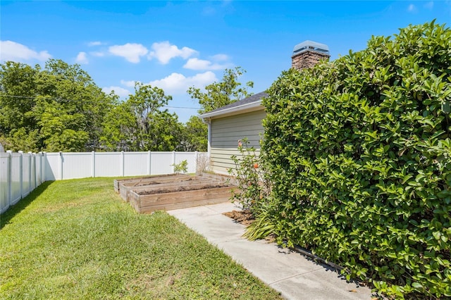 view of yard featuring a vegetable garden and fence