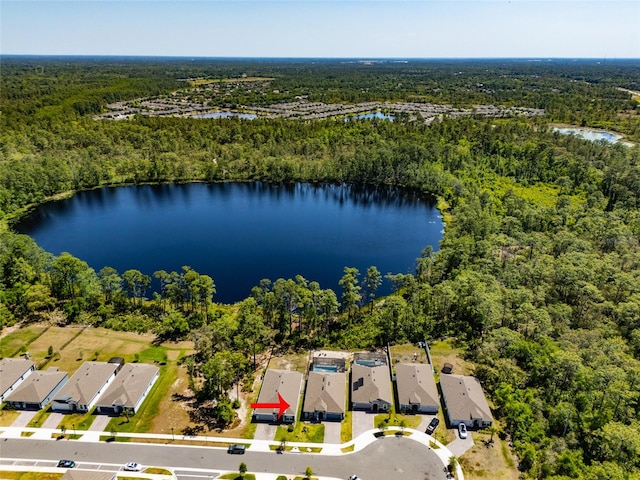 birds eye view of property with a view of trees, a residential view, and a water view