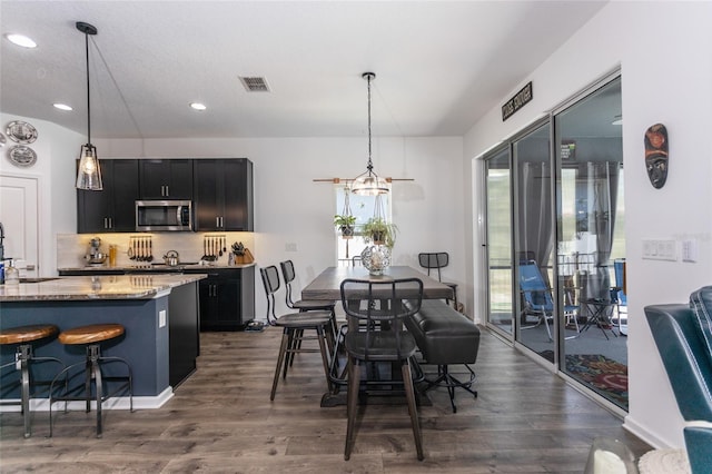 dining space with visible vents, recessed lighting, and dark wood-style floors