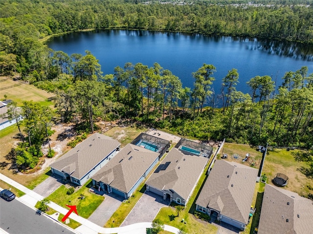 aerial view with a forest view and a water view