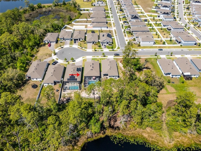 drone / aerial view with a water view and a residential view