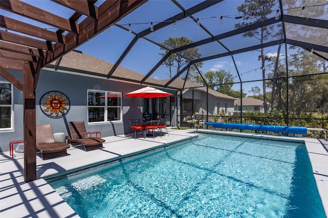 view of pool with glass enclosure, a covered pool, a patio, and a pergola