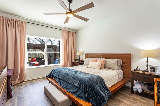 bedroom with a ceiling fan and wood finished floors