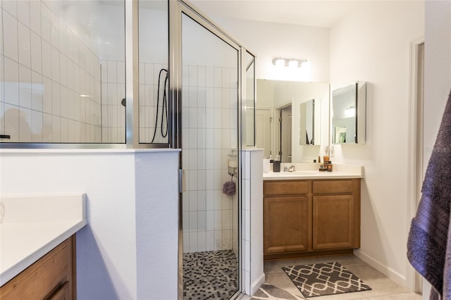 bathroom featuring tile patterned floors, a stall shower, and vanity