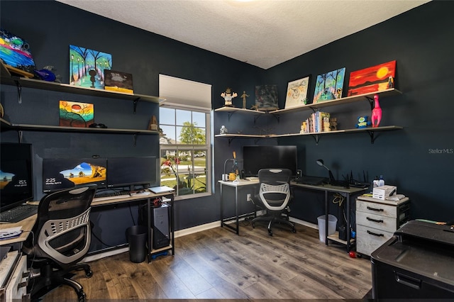 office featuring baseboards and wood finished floors