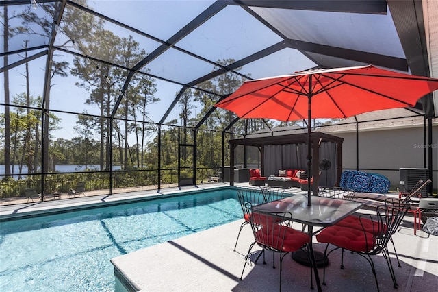 pool with an outdoor living space, a patio, and glass enclosure