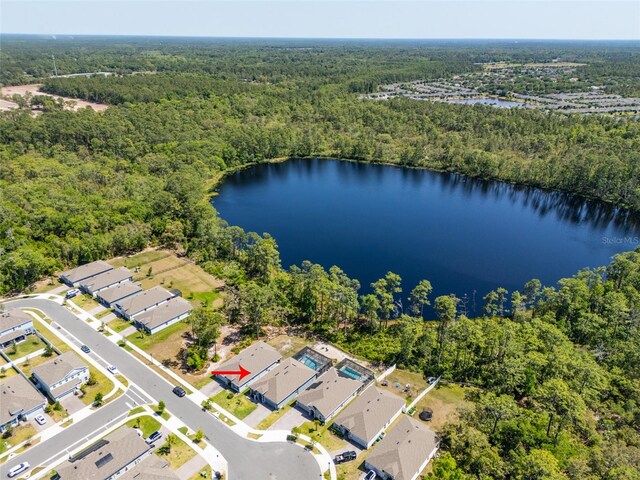 bird's eye view featuring a view of trees, a residential view, and a water view