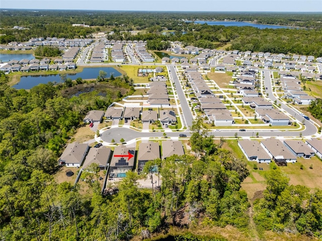 drone / aerial view with a residential view and a water view