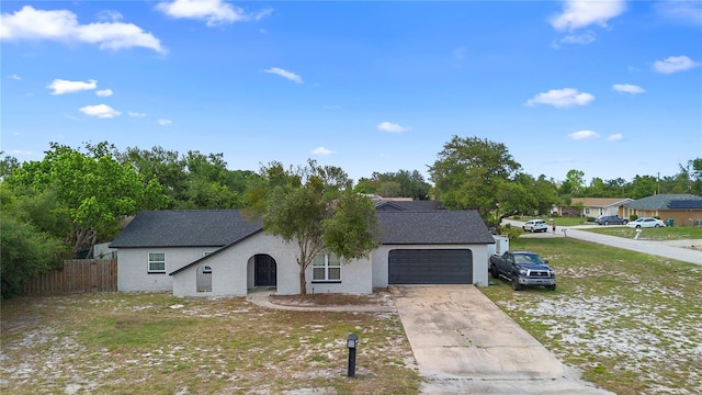1202 Anderson St, Deltona, FL 32725 - ranch-style home with stucco siding, fence, an attached garage, a shingled roof, and concrete driveway