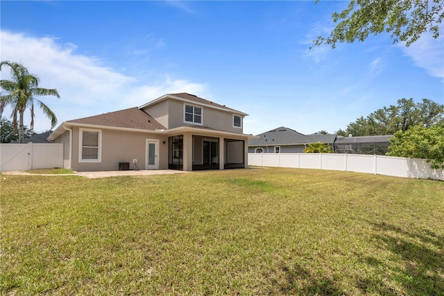 rear view of property with a fenced backyard, a patio, stucco siding, and a yard