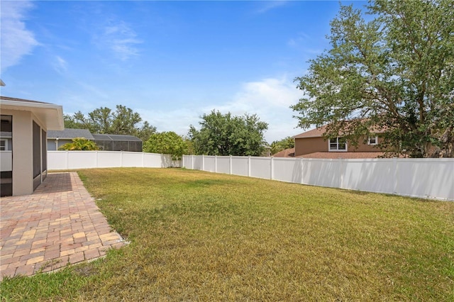 view of yard featuring a patio and fence