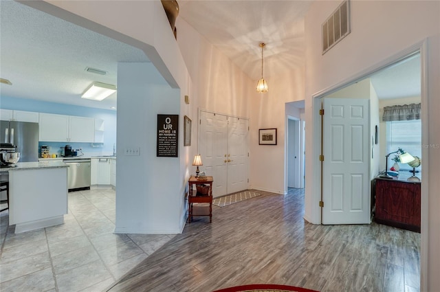 133 Wood Ibis Ct, Daytona Beach, FL 32119 - foyer featuring light wood finished floors, baseboards, and visible vents
