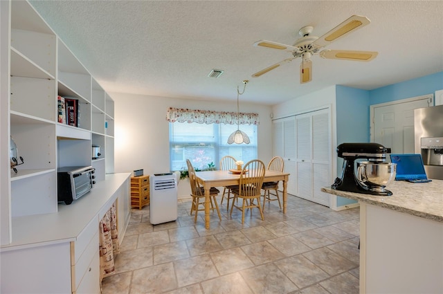 133 Wood Ibis Ct, Daytona Beach, FL 32119 - dining space featuring visible vents, a ceiling fan, and a textured ceiling