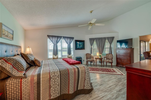 133 Wood Ibis Ct, Daytona Beach, FL 32119 - bedroom featuring a ceiling fan, wood finished floors, vaulted ceiling, and a textured ceiling