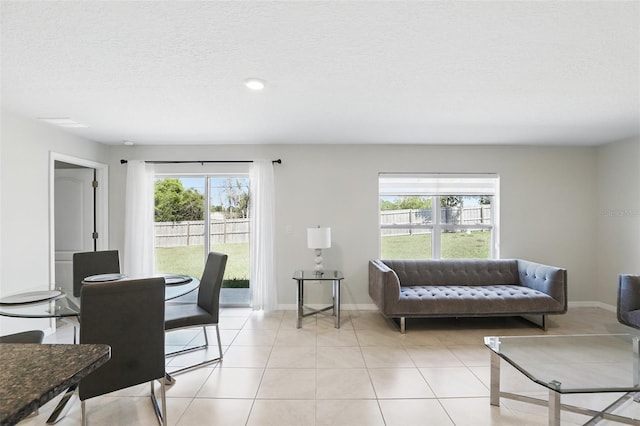 223 Courtland Blvd, Deltona, FL 32738 - living area with light tile patterned floors, baseboards, plenty of natural light, and a textured ceiling