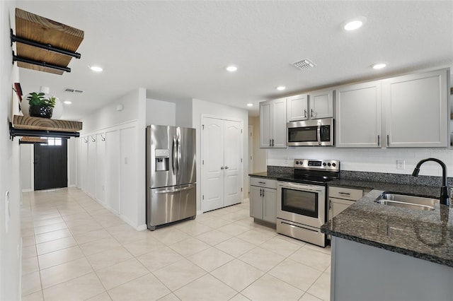 223 Courtland Blvd, Deltona, FL 32738 - kitchen featuring a sink, visible vents, appliances with stainless steel finishes, and dark stone counters