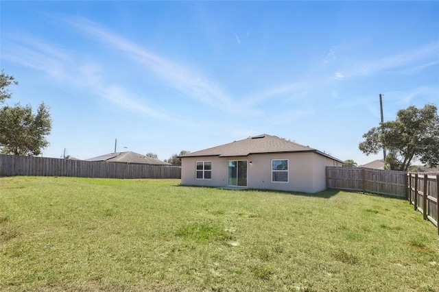 223 Courtland Blvd, Deltona, FL 32738 - back of property featuring a yard, a fenced backyard, and stucco siding