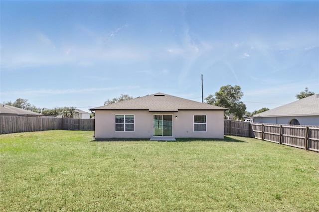 223 Courtland Blvd, Deltona, FL 32738 - rear view of property featuring a yard, a fenced backyard, and stucco siding
