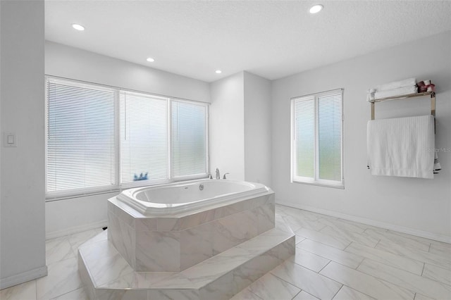 full bath featuring baseboards, recessed lighting, marble finish floor, and a bath